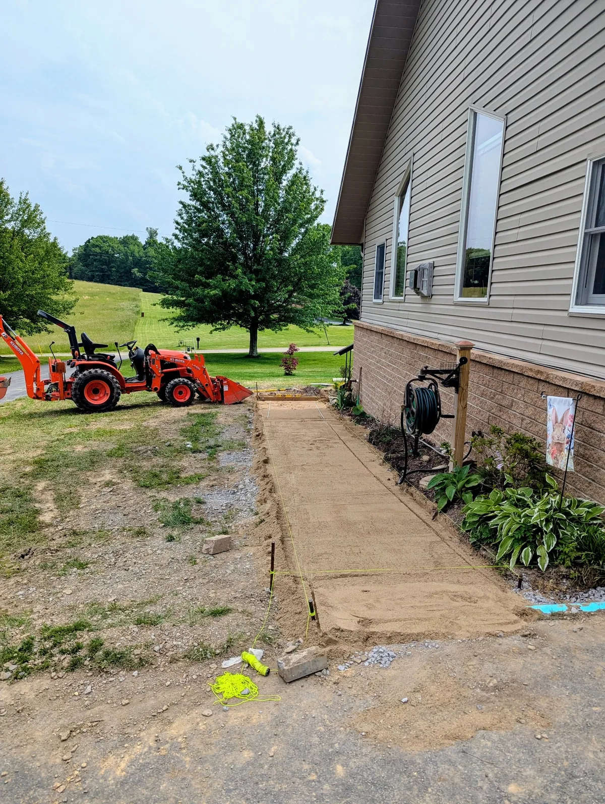 Pad preparation area being graded beside a building